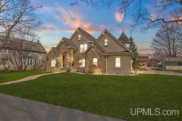 212 S 1st Ave, Escanaba, MI 49829 - view of front facade featuring stone siding and a front yard