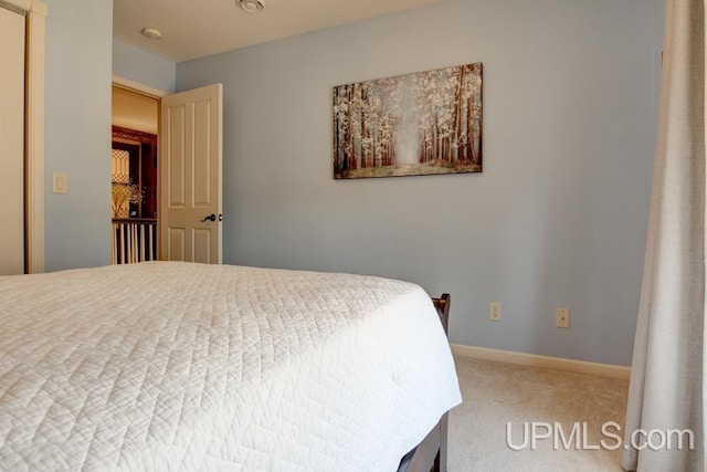 212 S 1st Ave, Escanaba, MI 49829 - carpeted bedroom featuring baseboards