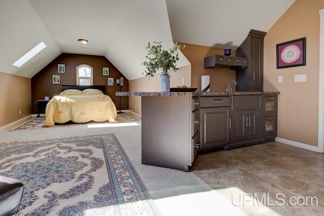 212 S 1st Ave, Escanaba, MI 49829 - bedroom featuring vaulted ceiling, baseboards, and a sink