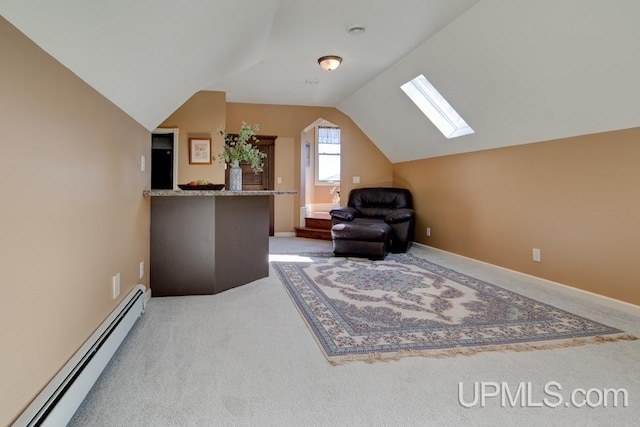 212 S 1st Ave, Escanaba, MI 49829 - sitting room featuring baseboard heating, light colored carpet, a skylight, lofted ceiling, and baseboards