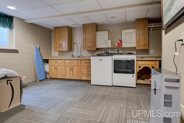 212 S 1st Ave, Escanaba, MI 49829 - kitchen with separate washer and dryer, a paneled ceiling, a sink, light countertops, and light carpet