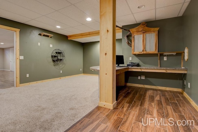 212 S 1st Ave, Escanaba, MI 49829 - finished below grade area featuring a drop ceiling, baseboards, wood finished floors, and recessed lighting