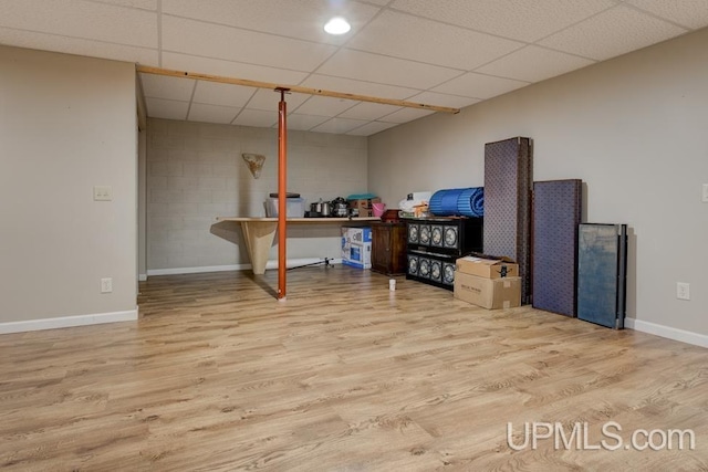 212 S 1st Ave, Escanaba, MI 49829 - finished below grade area with wood finished floors, baseboards, and a drop ceiling