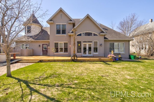 212 S 1st Ave, Escanaba, MI 49829 - rear view of house with french doors, a wooden deck, and roof with shingles