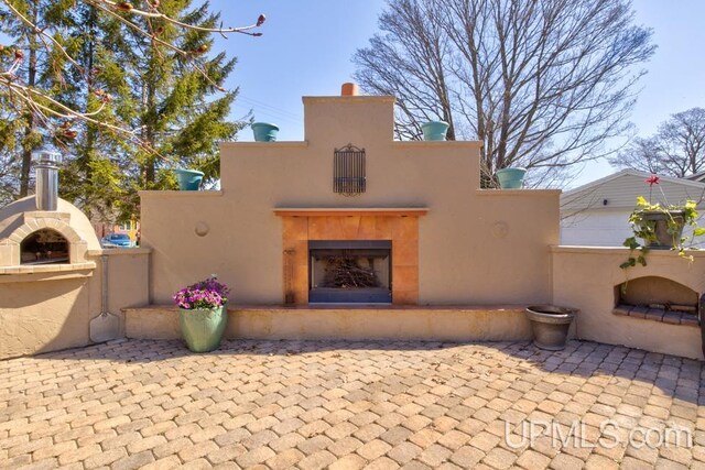 212 S 1st Ave, Escanaba, MI 49829 - view of front of house featuring a fireplace and a patio area