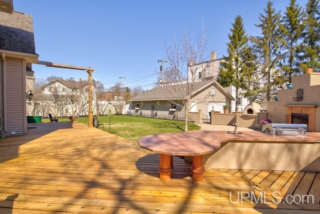 212 S 1st Ave, Escanaba, MI 49829 - deck featuring a lawn and an outbuilding