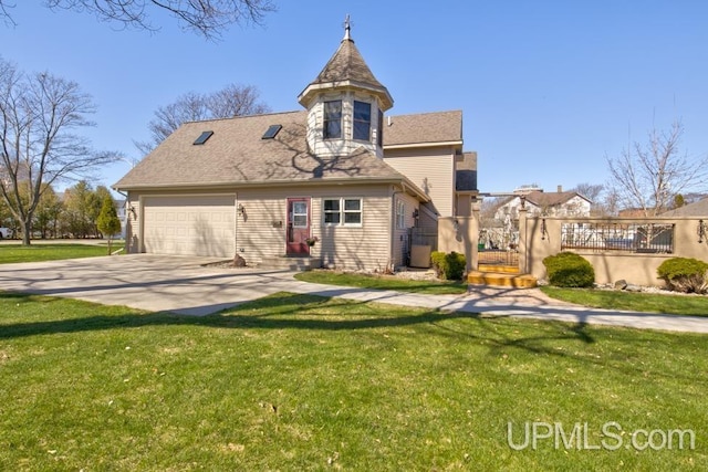 212 S 1st Ave, Escanaba, MI 49829 - view of front facade featuring a front lawn, driveway, and a garage