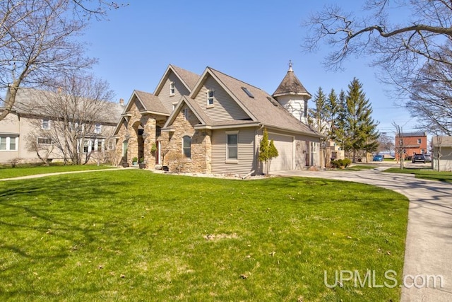212 S 1st Ave, Escanaba, MI 49829 - view of front of house with concrete driveway, stone siding, an attached garage, and a front lawn