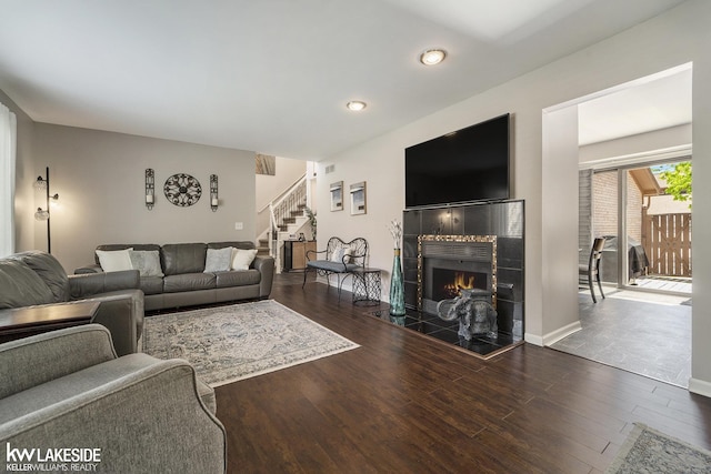 living room with stairway, a fireplace, wood finished floors, and recessed lighting