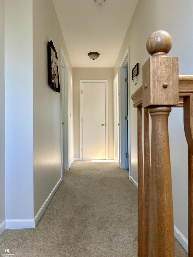 hall with carpet flooring and baseboards