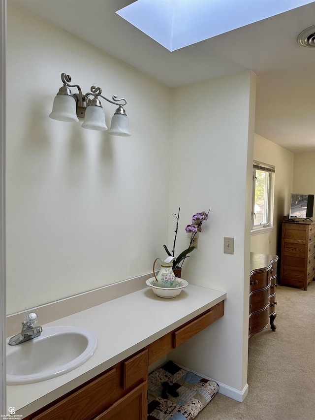 bathroom with a sink and a skylight