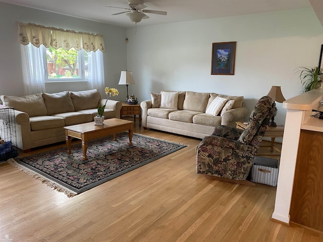 living room with a ceiling fan and wood finished floors