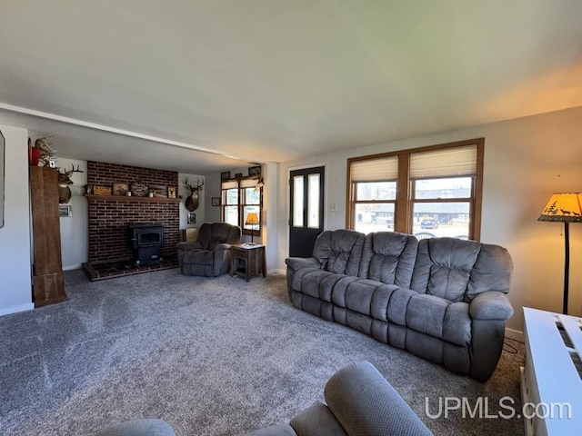 437 N Main St, Lanse, MI 49946 - carpeted living area with baseboards and a wood stove