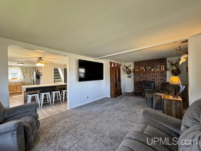 437 N Main St, Lanse, MI 49946 - living area featuring stairway, carpet, baseboards, and ceiling fan