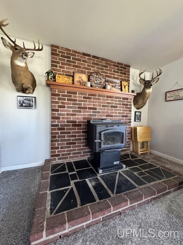 437 N Main St, Lanse, MI 49946 - detailed view of a wood stove, carpet flooring, and baseboards