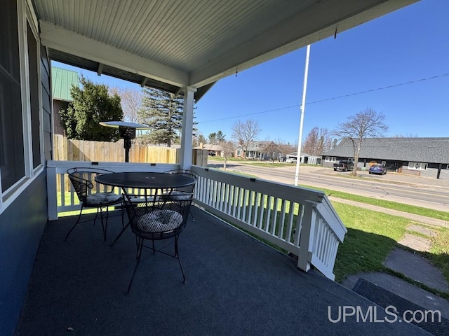 437 N Main St, Lanse, MI 49946 - view of patio / terrace with a residential view, fence, and a porch