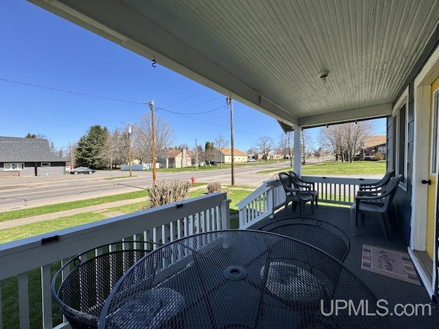 437 N Main St, Lanse, MI 49946 - wooden terrace with covered porch and a residential view