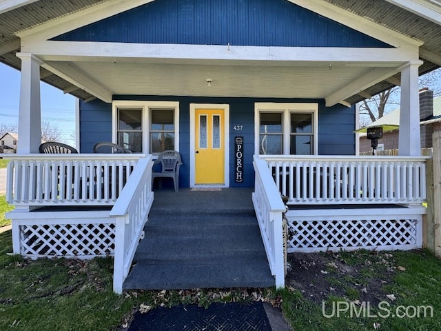 437 N Main St, Lanse, MI 49946 - view of exterior entry with a porch