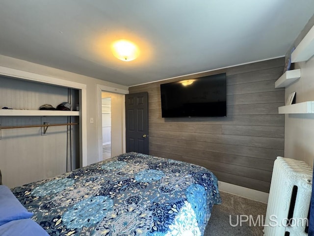 437 N Main St, Lanse, MI 49946 - carpeted bedroom with wooden walls, a closet, and baseboards