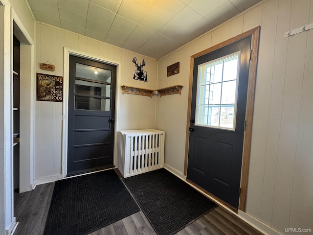 437 N Main St, Lanse, MI 49946 - entryway featuring dark wood-style flooring, a decorative wall, and ornamental molding