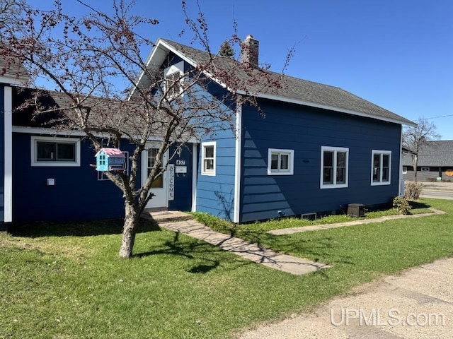 437 N Main St, Lanse, MI 49946 - view of property exterior with a chimney and a lawn