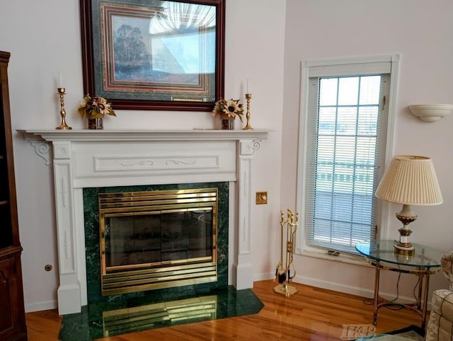 1726 Berkshire Dr, Gladwin, MI 48624 - detailed view of a tile fireplace, wood finished floors, and baseboards