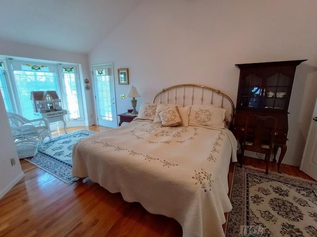 1726 Berkshire Dr, Gladwin, MI 48624 - bedroom featuring wood finished floors and high vaulted ceiling