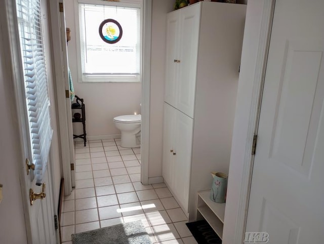 1726 Berkshire Dr, Gladwin, MI 48624 - bathroom with toilet, tile patterned floors, and baseboards