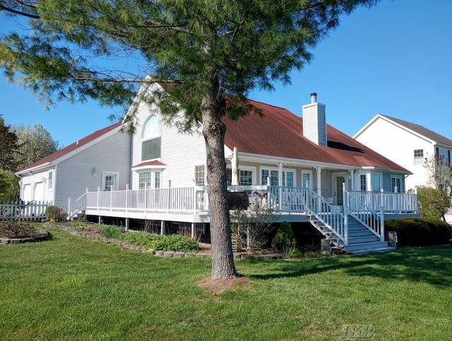 1726 Berkshire Dr, Gladwin, MI 48624 - rear view of property with a chimney, a yard, and covered porch