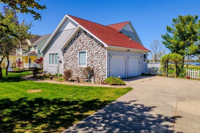 1726 Berkshire Dr, Gladwin, MI 48624 - view of side of home with stone siding, an attached garage, and driveway