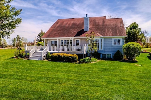 1726 Berkshire Dr, Gladwin, MI 48624 - back of house with a wooden deck, a chimney, and a lawn