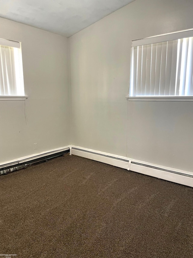 spare room with carpet flooring and baseboard heating