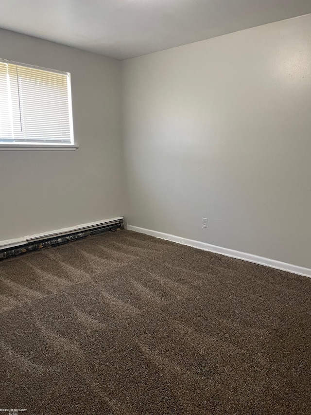carpeted spare room featuring baseboards and baseboard heating