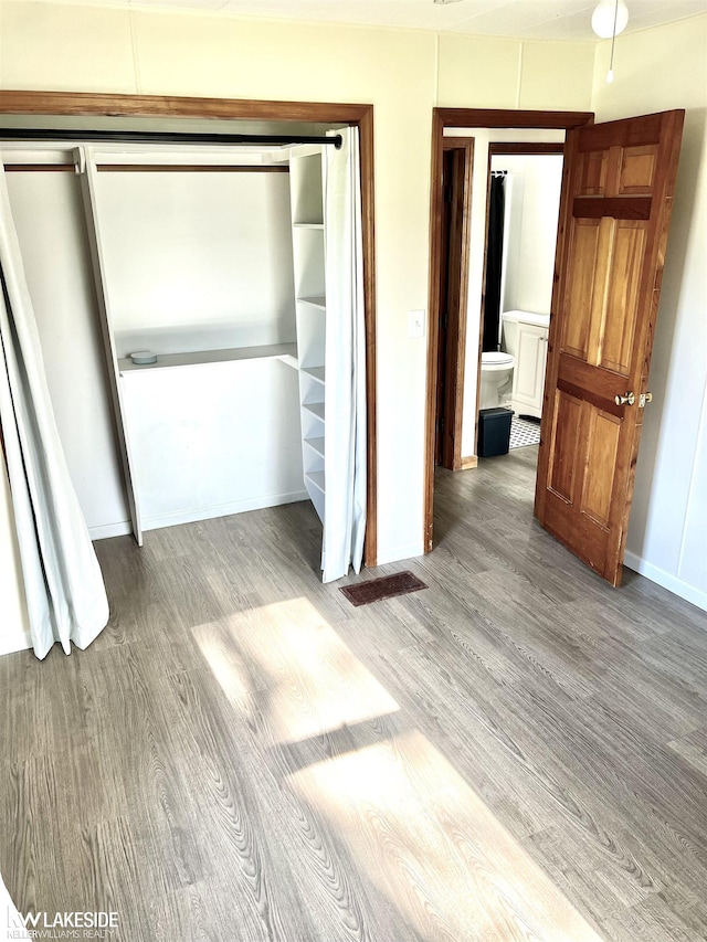 9602 Cornell Ave, Clarkston, MI 48348 - unfurnished bedroom with wood finished floors and baseboards