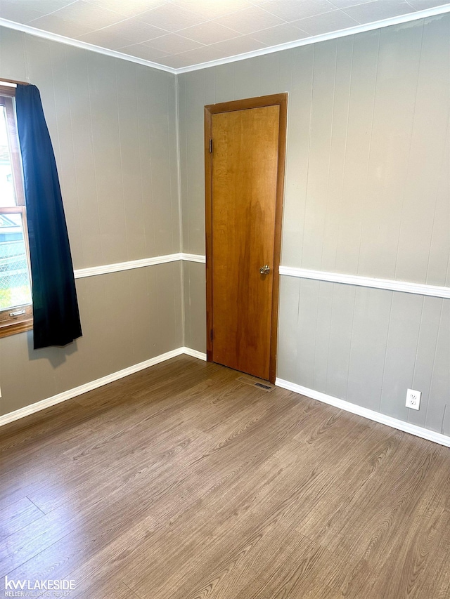 9602 Cornell Ave, Clarkston, MI 48348 - empty room featuring crown molding, wood finished floors, and baseboards