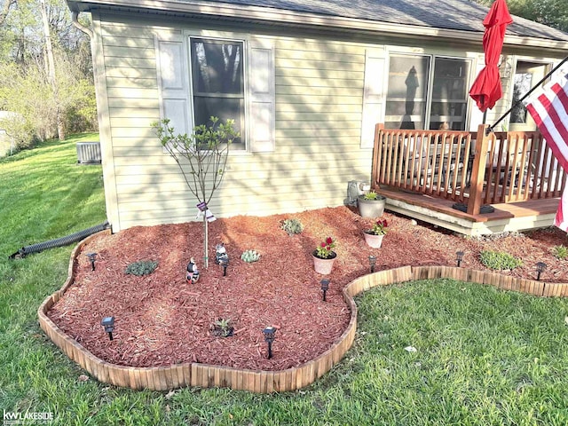 9602 Cornell Ave, Clarkston, MI 48348 - view of home's exterior with a yard, a wooden deck, roof with shingles, and cooling unit