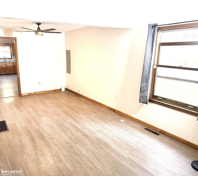 9602 Cornell Ave, Clarkston, MI 48348 - unfurnished room with light wood-type flooring, ceiling fan, electric panel, and baseboards