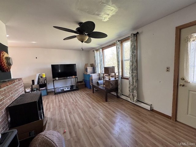 643 S Pine St, Ishpeming, MI 49849 - living room featuring light wood-style flooring, a baseboard heating unit, a ceiling fan, and baseboards