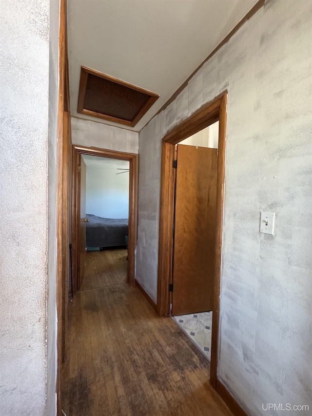643 S Pine St, Ishpeming, MI 49849 - hallway with hardwood / wood-style flooring and attic access