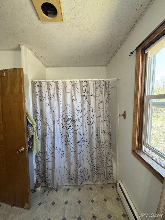 643 S Pine St, Ishpeming, MI 49849 - bathroom featuring tile patterned floors, shower / tub combo, a textured ceiling, and a baseboard heating unit