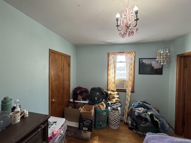 643 S Pine St, Ishpeming, MI 49849 - bedroom with wood finished floors and a chandelier