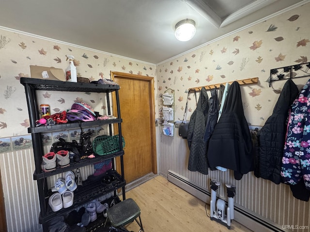 643 S Pine St, Ishpeming, MI 49849 - mudroom with wallpapered walls, wood finished floors, ornamental molding, and a baseboard heating unit