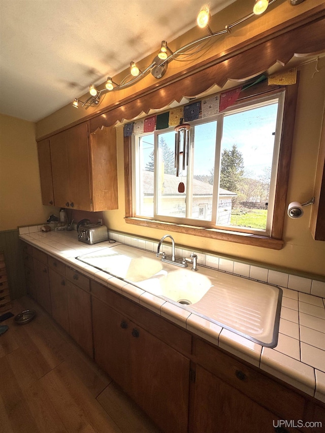 643 S Pine St, Ishpeming, MI 49849 - kitchen with healthy amount of natural light, tile countertops, and wood finished floors