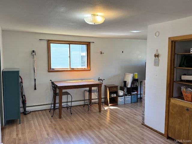 643 S Pine St, Ishpeming, MI 49849 - dining room with baseboard heating, light wood finished floors, and baseboards