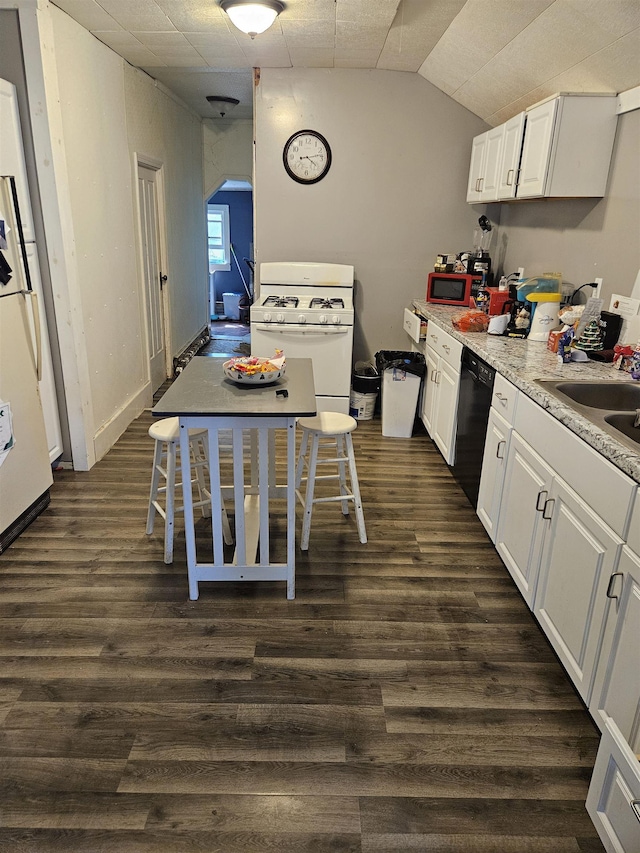 112 Euclid St, Saint Louis, MI 48880 - kitchen with white appliances, arched walkways, white cabinetry, dark wood-style flooring, and vaulted ceiling