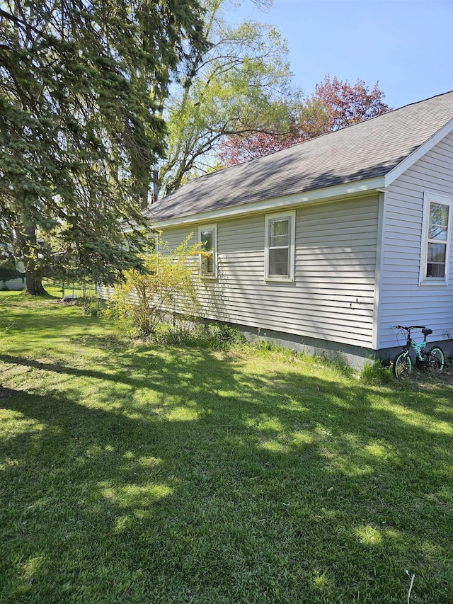 112 Euclid St, Saint Louis, MI 48880 - view of property exterior with a lawn and roof with shingles