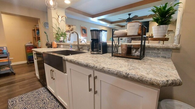 3787 Shepherd Rd, Midland, MI 48880 - kitchen featuring a sink, decorative backsplash, a ceiling fan, dark wood-style flooring, and white cabinets
