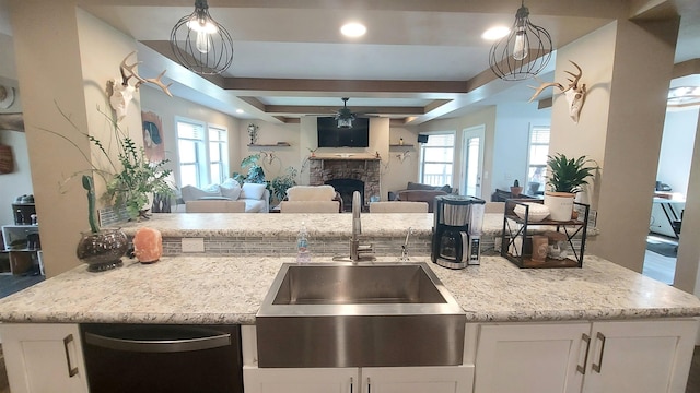 3787 Shepherd Rd, Midland, MI 48880 - kitchen with open floor plan, a sink, dishwasher, ceiling fan, and white cabinetry