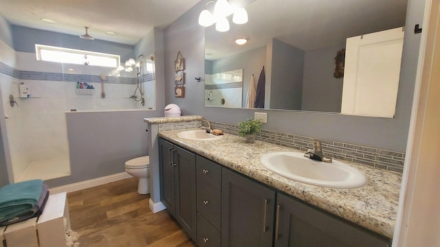 3787 Shepherd Rd, Midland, MI 48880 - full bath with walk in shower, wood finished floors, double vanity, toilet, and baseboards