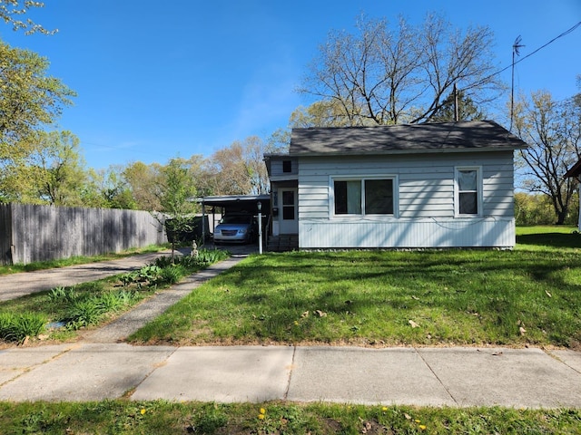 view of side of property featuring an attached carport and driveway